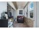 Bright and airy sunroom with brick accent wall, tile floors, and lots of windows at 1510 Palmer Ct, Palm Harbor, FL 34685