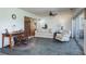 Bright sunroom with stone floors, furniture, ceiling fan, and sliding doors to exterior at 1510 Palmer Ct, Palm Harbor, FL 34685