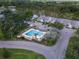 Aerial view of the community pool with several lounge chairs surrounded by lush greenery at 16175 Rambling Vine E Dr, Tampa, FL 33624