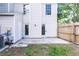 Rear view shows back door entrance, a concrete patio, and partial fencing at 16175 Rambling Vine E Dr, Tampa, FL 33624