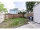 Fenced backyard offers a cozy outdoor space, perfect for relaxation, and a modern AC unit at 16175 Rambling Vine E Dr, Tampa, FL 33624