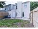 Exterior rear view shows two doors, a fenced in back, and concrete patio at 16175 Rambling Vine E Dr, Tampa, FL 33624