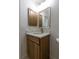 Bathroom features wood vanity, marble countertop, sink and framed mirror at 16175 Rambling Vine E Dr, Tampa, FL 33624