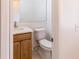 Bathroom featuring a light wood vanity, marble countertop, sink, and a toilet at 16175 Rambling Vine E Dr, Tampa, FL 33624
