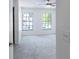 Light filled bedroom with two large windows and neutral carpet at 16175 Rambling Vine E Dr, Tampa, FL 33624