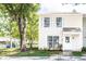 Charming two-story condo featuring white siding, white trimmed windows, and landscaped yard at 16175 Rambling Vine E Dr, Tampa, FL 33624