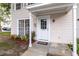 Inviting front entrance features a classic white door, covered porch, and a 'Welcome' mat, enhancing the curb appeal at 16175 Rambling Vine E Dr, Tampa, FL 33624