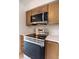 Close up of the stainless steel oven, microwave, and quartz countertop at 16175 Rambling Vine E Dr, Tampa, FL 33624