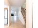 Open concept floor plan featuring tile floors and stairs leading to the second floor at 16175 Rambling Vine E Dr, Tampa, FL 33624