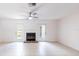 Bright living room with fireplace, tile floors, ceiling fan, and access to the backyard at 16175 Rambling Vine E Dr, Tampa, FL 33624
