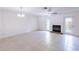 Large living room with neutral colored tile flooring and a fireplace at 16175 Rambling Vine E Dr, Tampa, FL 33624