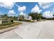 Entrance to the Country Mill community showcasing lush landscaping and inviting street view on a bright, sunny day at 16175 Rambling Vine E Dr, Tampa, FL 33624