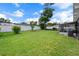Expansive backyard featuring a screened in porch and white vinyl fence at 1707 Windsor Way, Tampa, FL 33619