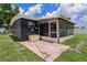 Home's backyard featuring a patio, screened in porch and storage unit at 1707 Windsor Way, Tampa, FL 33619