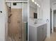 Bathroom featuring a glass door shower and vanity with a sink and mirror at 1707 Windsor Way, Tampa, FL 33619