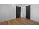 Bedroom with hardwood floors, white walls, and a dark closet at 1707 Windsor Way, Tampa, FL 33619
