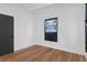 Bedroom with hardwood floors, white walls, and a dark closet at 1707 Windsor Way, Tampa, FL 33619