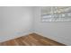 Bedroom featuring a hardwood floor, white walls, and a large window at 1707 Windsor Way, Tampa, FL 33619