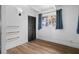 Bright bedroom featuring a closet, hardwood floors, shelving and a window with curtains at 1707 Windsor Way, Tampa, FL 33619