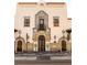 Unique building exterior with mosaic tile accents and a detailed archway entrance, complemented by decorative sconces at 1707 Windsor Way, Tampa, FL 33619