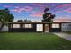 Stunning front view of the property with decorative shutters and freshly painted exterior, under a colorful sunset at 1707 Windsor Way, Tampa, FL 33619