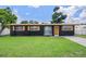 Charming single-story home featuring a well-maintained lawn, freshly painted exterior, and decorative shutters at 1707 Windsor Way, Tampa, FL 33619