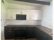 Bright kitchen with white upper cabinets, black lower cabinets, butcher block counters and modern appliances at 1707 Windsor Way, Tampa, FL 33619
