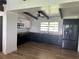 Modern kitchen boasts sleek, contrasting cabinets, stainless appliances, butcher block countertops, and wood floors at 1707 Windsor Way, Tampa, FL 33619