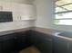 Stylish black and white kitchen with new countertops, and stainless steel appliances at 1707 Windsor Way, Tampa, FL 33619