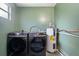 Laundry room with a washer, dryer, and water heater at 1707 Windsor Way, Tampa, FL 33619