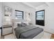 Staged main bedroom featuring contemporary decor, soft lighting, art, and a comfortable bed at 1707 Windsor Way, Tampa, FL 33619