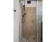Shower featuring tan tiled walls and a glass door at 1707 Windsor Way, Tampa, FL 33619