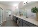 Modern bathroom featuring dual sinks, quartz countertops, vanity space, and walk-in shower at 17140 Holly Well Ave, Wimauma, FL 33598