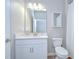 Bathroom featuring a white cabinet sink, a large mirror, and a toilet at 17140 Holly Well Ave, Wimauma, FL 33598
