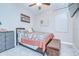 Bedroom featuring a comfortable bed, ceiling fan, and a gray storage dresser at 17140 Holly Well Ave, Wimauma, FL 33598