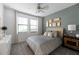 Well-lit bedroom featuring neutral gray tones, crown molding, and a ceiling fan at 17140 Holly Well Ave, Wimauma, FL 33598
