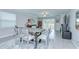 Open dining area seamlessly connecting to the living room, with stylish furniture and natural light at 17140 Holly Well Ave, Wimauma, FL 33598
