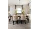 Elegant dining room with wood flooring, neutral colors, plenty of natural light, and seating for six at 17140 Holly Well Ave, Wimauma, FL 33598