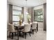 Elegant dining room with wood flooring, neutral colors, plenty of natural light, and seating for six at 17140 Holly Well Ave, Wimauma, FL 33598