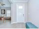 Bright foyer with wood-look tile flooring and neutral paint, creating a welcoming entrance at 17140 Holly Well Ave, Wimauma, FL 33598