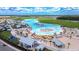 Aerial view of lagoon with sandy beaches, water activities, and community amenities at 17140 Holly Well Ave, Wimauma, FL 33598