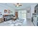 Cozy living room featuring a large sliding glass door, stylish furnishings, and modern decor at 17140 Holly Well Ave, Wimauma, FL 33598