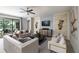 Bright living room with neutral furniture, modern decor, and sliding doors to the outdoors at 17140 Holly Well Ave, Wimauma, FL 33598