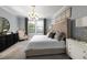 Serene main bedroom featuring a plush bed, soft lighting, and elegant furnishings at 17140 Holly Well Ave, Wimauma, FL 33598
