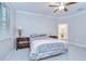 Calming main bedroom features neutral colors, a ceiling fan, and an ensuite bathroom at 17140 Holly Well Ave, Wimauma, FL 33598
