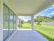 Covered patio with a view of the green, well-maintained backyard at 17140 Holly Well Ave, Wimauma, FL 33598