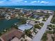 This aerial view features the home within its coastal neighborhood near the beach at 202 Howard Dr, Belleair Beach, FL 33786