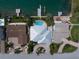 Charming single-Gathering homes with lush landscaping, complemented by a sparkling pool and dock access at 202 Howard Dr, Belleair Beach, FL 33786
