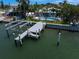 Waterfront home featuring a private dock, lift, and swimming pool at 202 Howard Dr, Belleair Beach, FL 33786