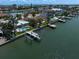 An aerial photo of a waterfront home with a dock and private pool at 202 Howard Dr, Belleair Beach, FL 33786